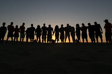 People Silhouetted in Sunset